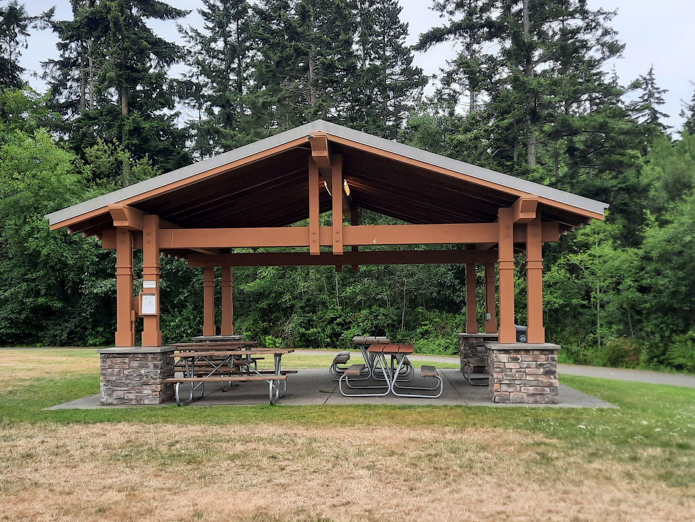 Open-air covered shelter with picnic tables